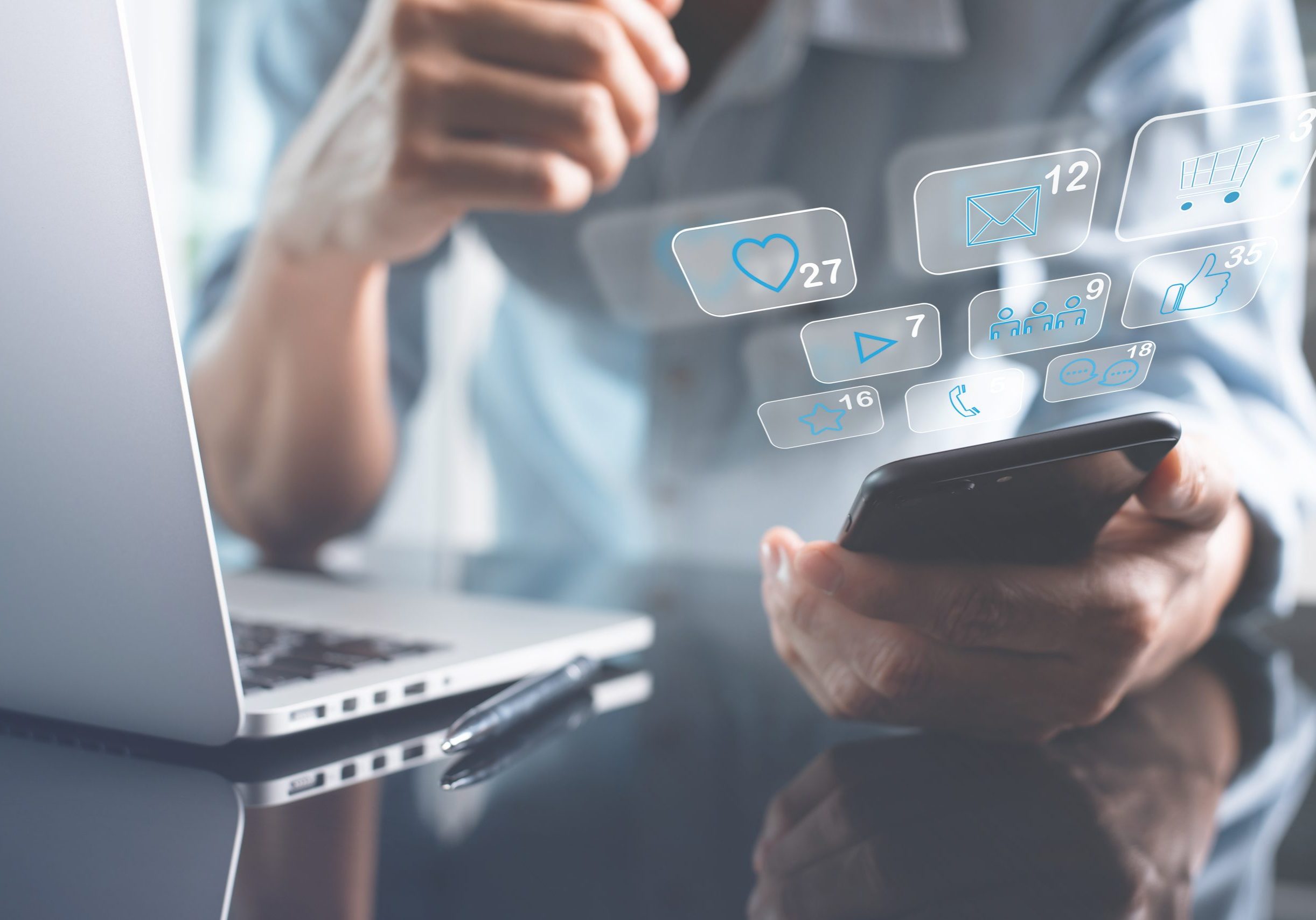 Digital marketing, online shopping, social media advertising, mobile application, Ecommerce concept. Man using mobile smart phone with social network icons on virtual screen